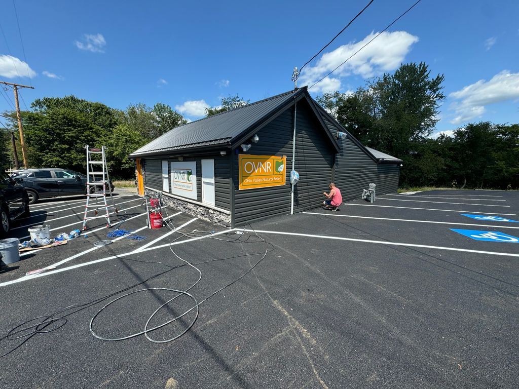 Commercial building exterior painted by Five-OH Painting