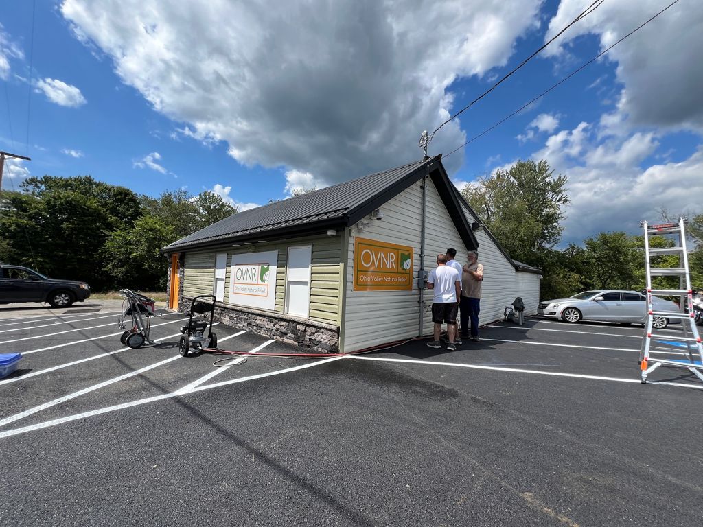 Painters working on a commercial building exterior